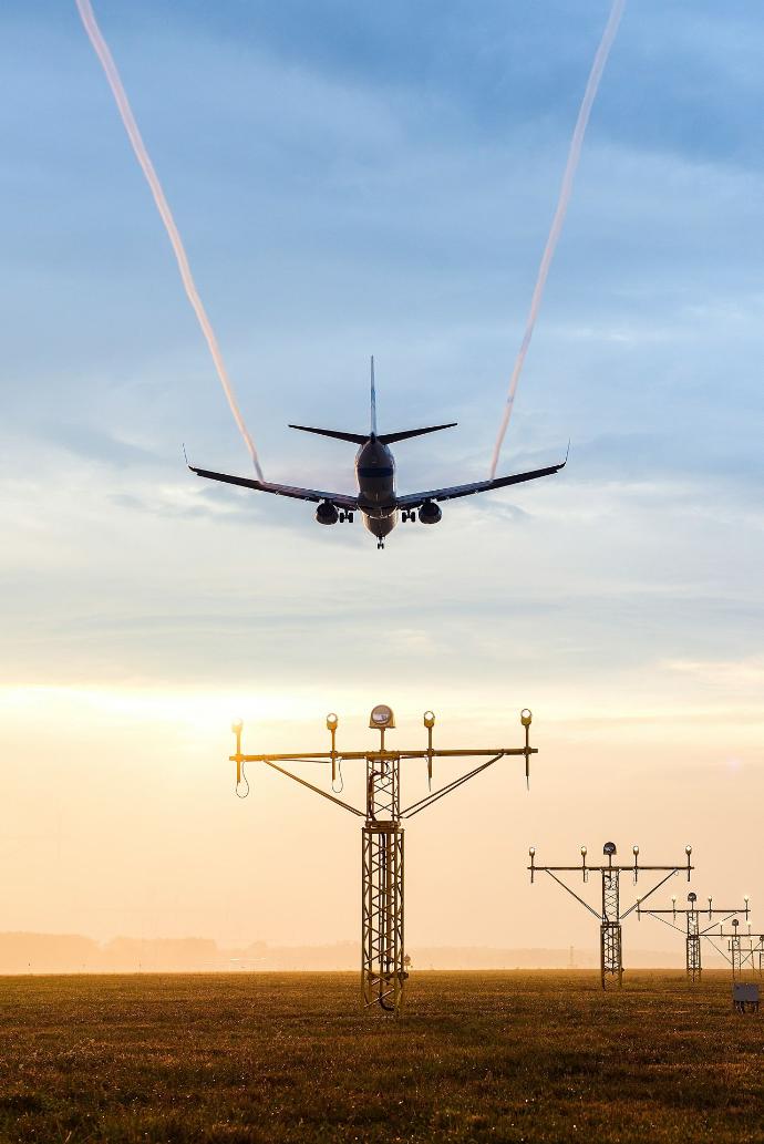 plane over electric tower